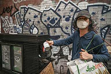 The vanishing of Lower Manhattan’s community fridges: Where are they now and how has their absence affected the homeless? 2 Woman standing next to community fridge in Manhattan
