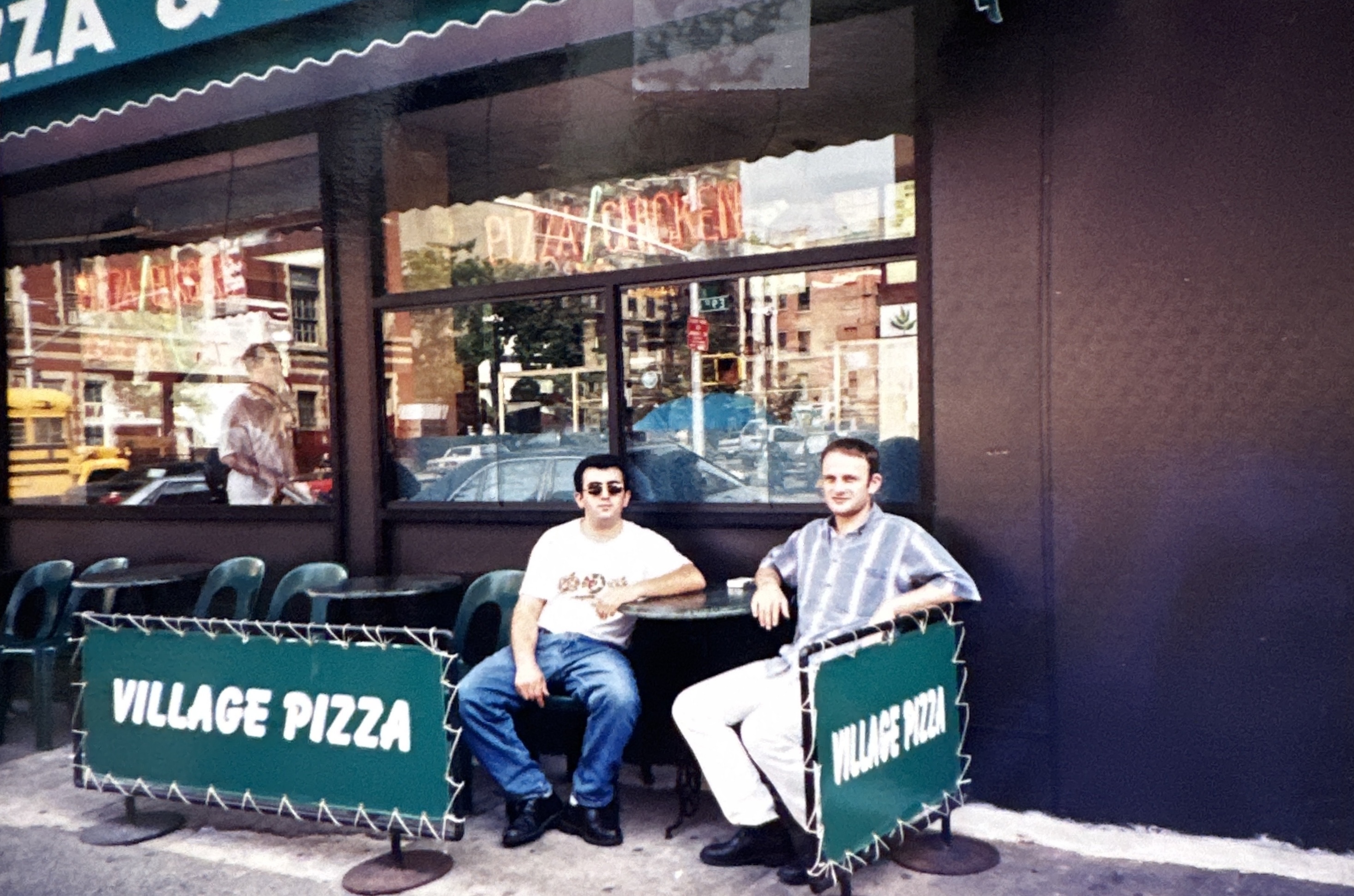Frank and his cousin sit outside of East Village Pizza.