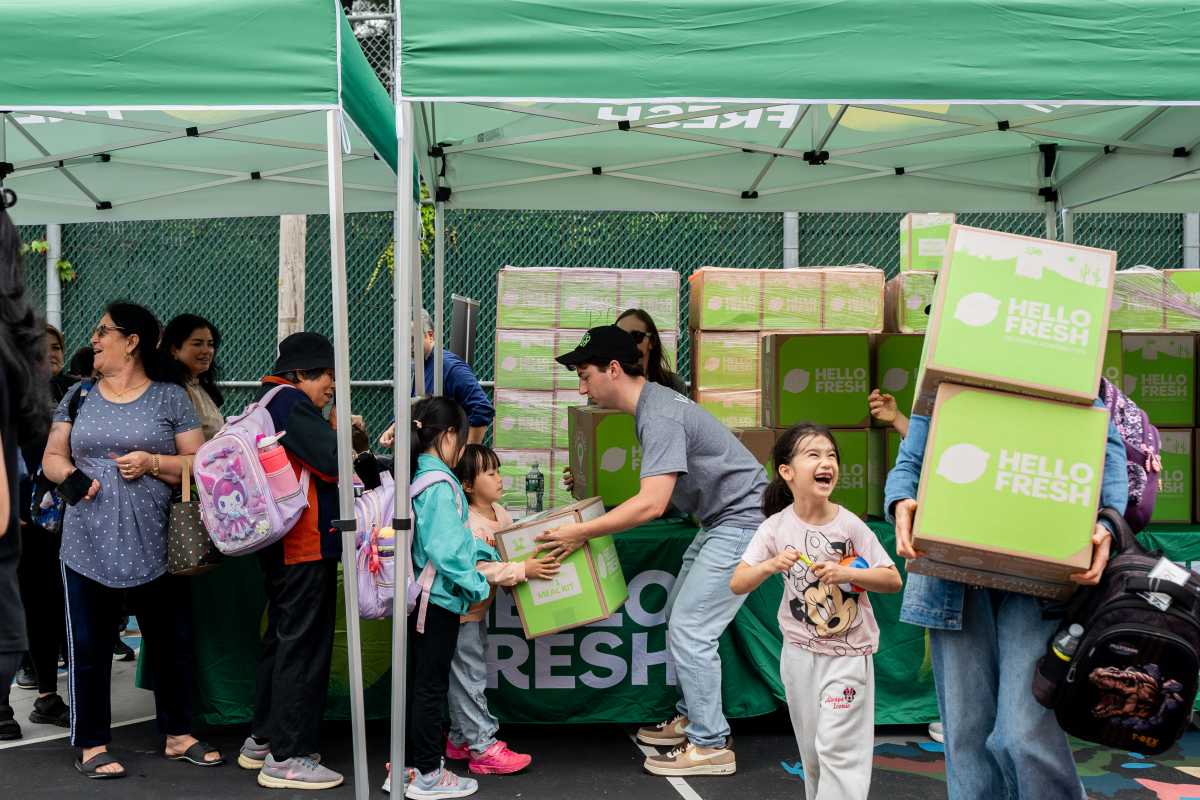 volunteers hand out HelloFresh boxes to new york families facing food insecurity