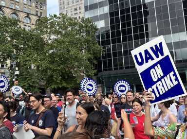 As threat of mass strike looms, some NYC legal service providers reach tentative agreements with unions 21 Unionized public interest attorneys in NYC holding banners during a strike for better wages, lower caseloads, and retirement benefits.