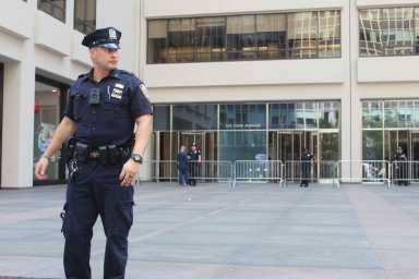 MIDTOWN MASS SHOOTING: Life resumes under eerie calm near Park Avenue office building the day after tragedy unfolded 43 A police officer stands guard at the entrance to 345 Park Ave., the point of entry for the gunman in Monday’s fatal Midtown shooting.