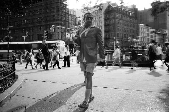 Photo Perspective: A New York summer caught on film 31 A man in shorts striding along a New York City sidewalk during summer in black and white