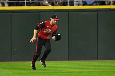 Austin Slater Yankees: Man in red and black uniform catches baseball