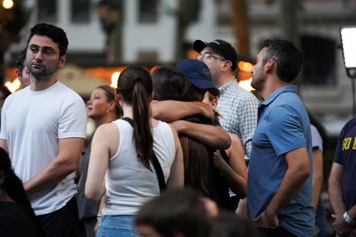 New Yorkers gather in Bryant Park to grief Midtown mass shooting victims, vow 'we are stronger together' 11 people embrace during a candlelight vigil in Bryant Park