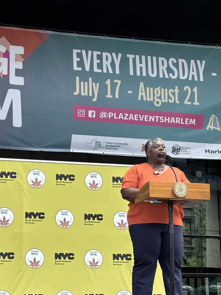 Budding idea: NYC ought to be the 'cannabis capital' of America, Mayor Adams says at Harlem fair 3 woman in orange shirt speaks at podium