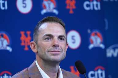 Mets legend David Wright continues a tradition of honoring New York's heroes at 'Battle of the Badges' baseball game 25 David Wright: Man in suit smiles in front of blue and orange backdrop