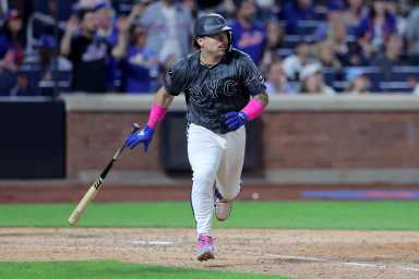 Francisco Alvarez Mets: Baseball player in grey uniform and white pants dropping bat after hitting ball