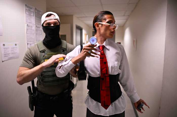 ICE in courts: More immigrants cuffed at Federal Plaza as even officers feel the strain 14 two people in a hallway, one of them being brought out by a federal agent