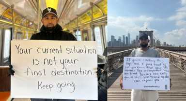 Jose Cruz holding signs