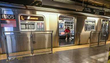 a NYC train with its doors open in a station