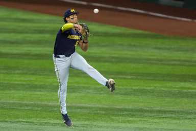 Mitch Voit Mets: Baseball player in blue jersey leaping and throwing ball