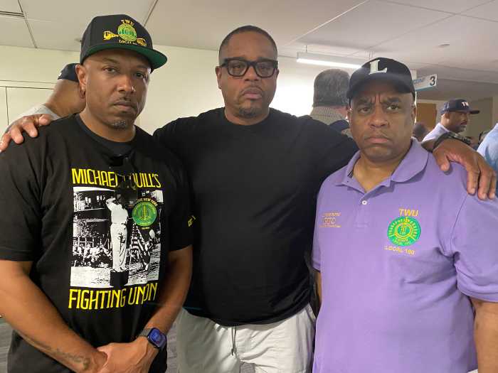 MTA’s transition to outside workers’ comp firm result in thousands of payment delays for employees 4 three men standing in a room, two wearing black shirts, one wearing a purple shirt