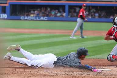 Tyrone Taylor Mets: Baseball player in grey uniform slides safely into home plate