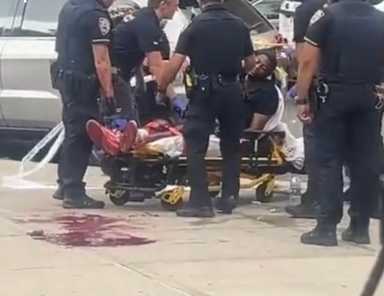 Harlem shooting: Man wounded, teen suspect arrested after cop shoots at him 14 Police officers tend to shooting victim lying in pool of blood on gurney in Harlem