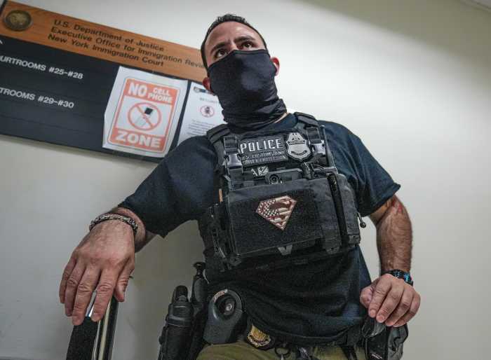 ICE agent in court with Superman patch on his vest