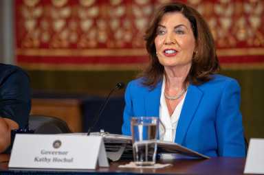 Hochul labels Texas GOP redistricting a ‘legal insurrection,’ urges Democrats to fight back 4 a woman sits at a table. Governor Kathy Hochul