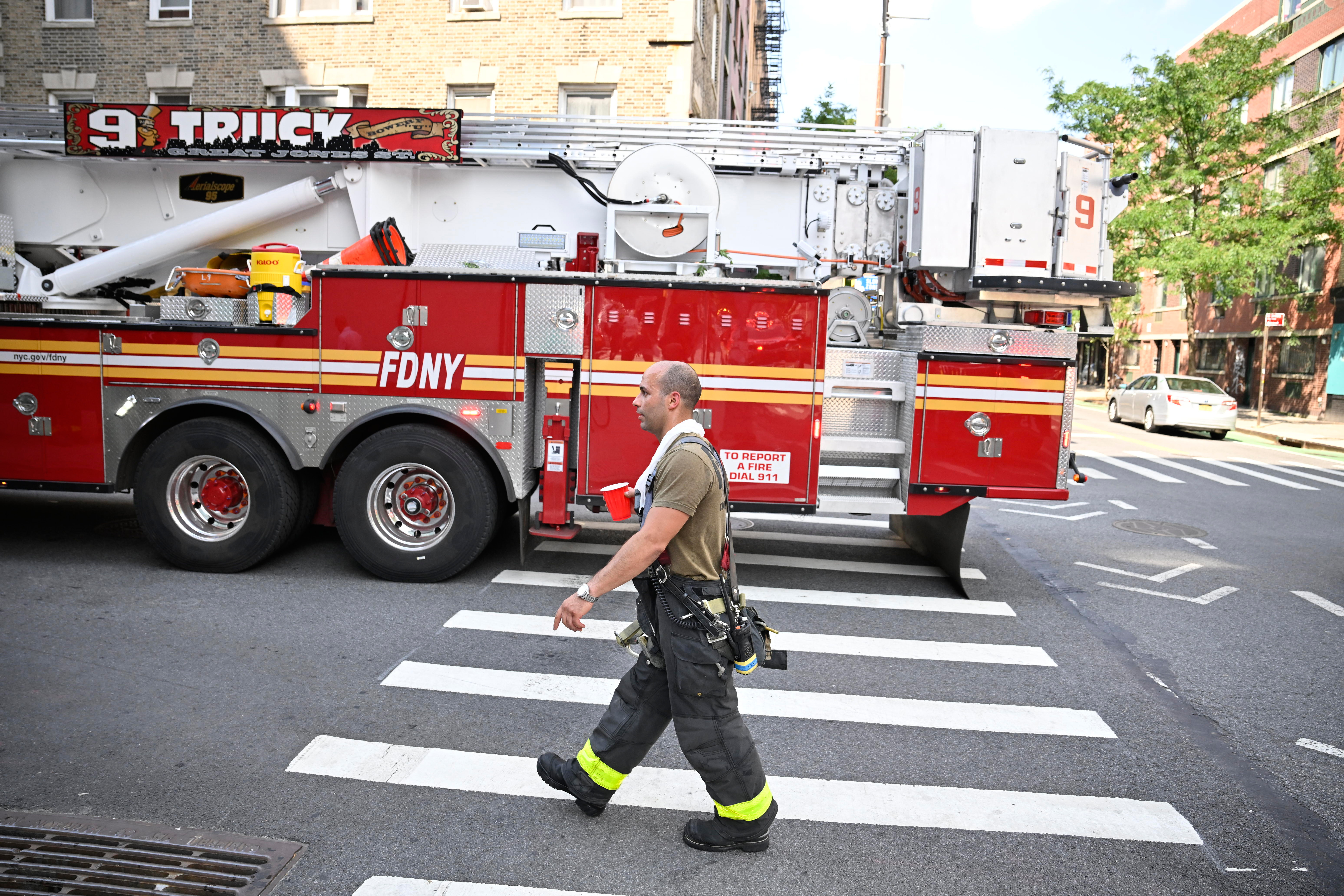 Fire rips through Lower East Side building rooftop 4 A firefighter works to beat the heat as temps were in the mid 90's during an afternoon blaze in the lower East side on Monday, July, 28.