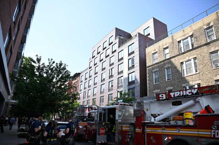 Fire rips through Lower East Side building rooftop 4 A firefighter works to beat the heat as temps were in the mid 90's during an afternoon blaze in the lower East side on Monday, July, 28.