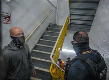 ICE in court: Temporary order blocking mass detainment at 26 Federal Plaza extended amid uncertainty 5 ICE agents in hallway of Federal Plaza questioning man during arrest