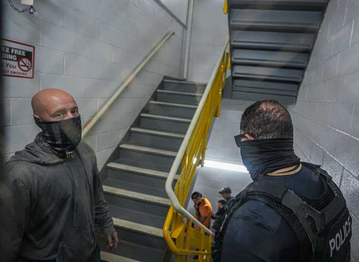 ICE in court: Temporary order blocking mass detainment at 26 Federal Plaza extended amid uncertainty 6 ICE agents in hallway of Federal Plaza questioning man during arrest