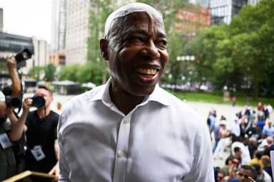 Mayor Eric Adams smiling and wearing shirt