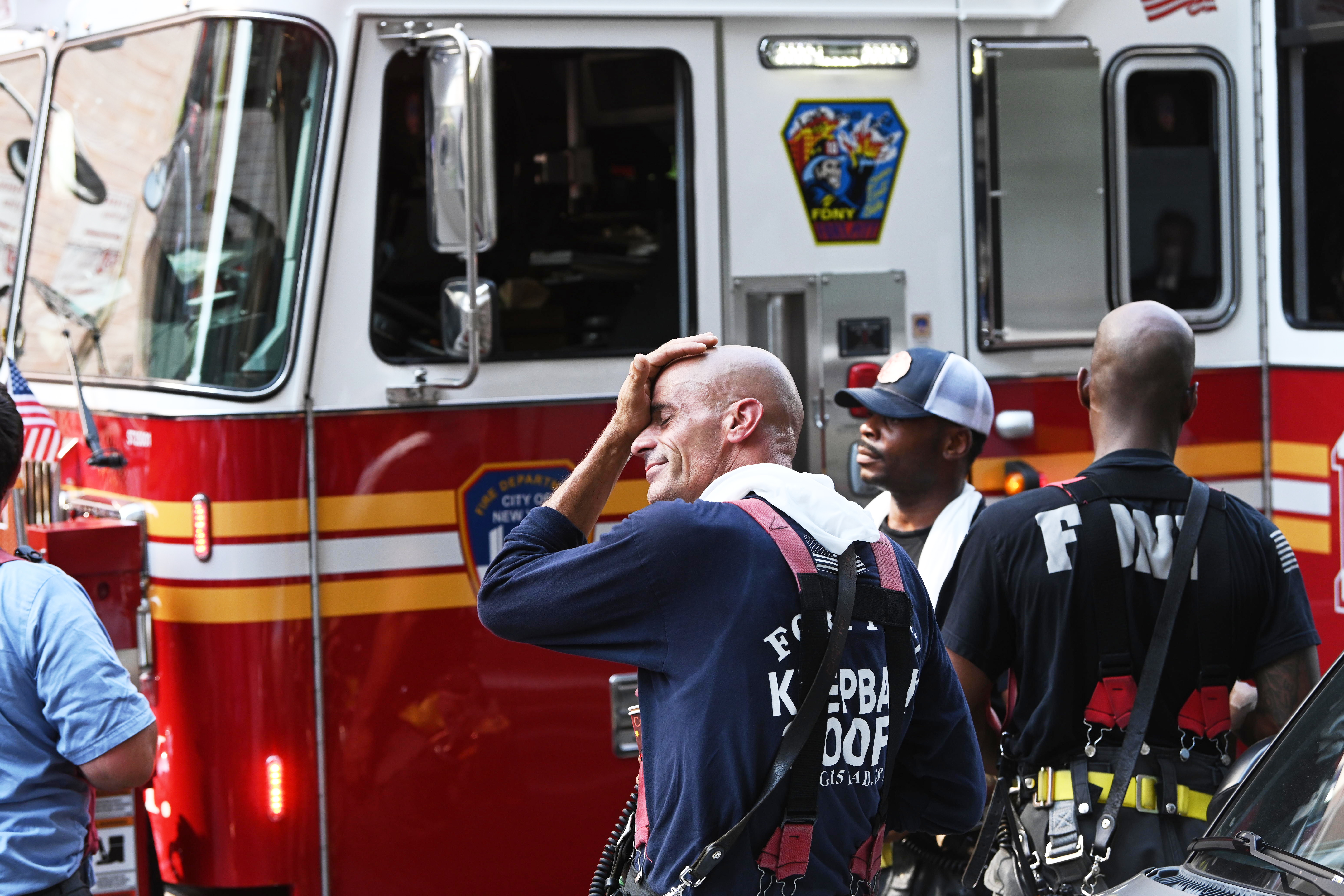 Fire rips through Lower East Side building rooftop 5 Firefighters try to cool off after a fire.