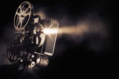 Bronx Fame teams up with One Man Army for film screening next month 11 Movie projector on a dark background with light beam / high contrast image