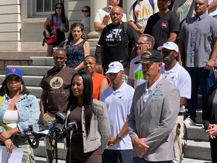 'Generational wealth to generational debt': Cannabis retailers warn of financial ruin without swift action on proximity rule 2 Nubia Ashley, owner of the women-led dispensary Residue, speaks at the City Hall rally, sharing how her fully built-out shop was barred from opening due to new proximity rules, leaving her in debt before even making a sale.