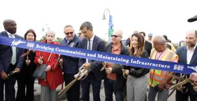 Iconic 145-year-old wooden bridge in Brooklyn gets a makeover 18 group of people near a bridge cutting a ribbon