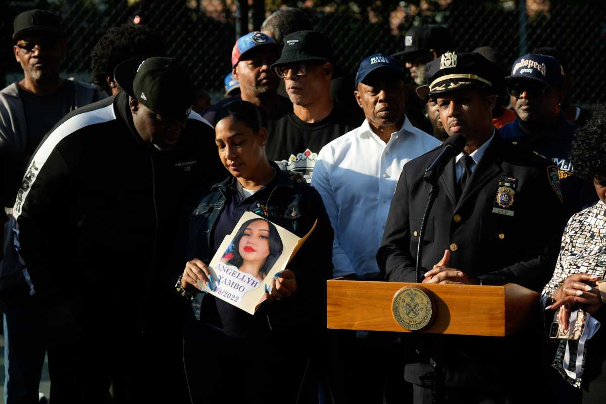Mayor Adams pledges more cops and violence interrupters amid uptick in Bronx shootings 2 NYPD executive speaking at podium surrounded by people and mayor talking about shootings