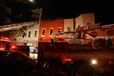 Brooklyn four-alarm fire leaves four firefighters and resident injured 11 firefighters with equipment in front of rowhouses in Brooklyn during fire