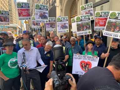 Fed up union members rally ouside Bottcher's office to rein in support for horse-carriage industry 23 large group of people holding signs at a protest