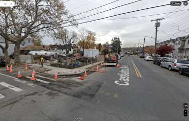 intersection with cars parked on the road