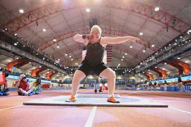 The Armory shotput: Man throws shotput in domed building